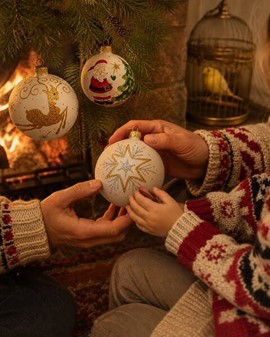 Julekugler fra Polen. Julemand, rensdyr og stjerne på hvid baggrund